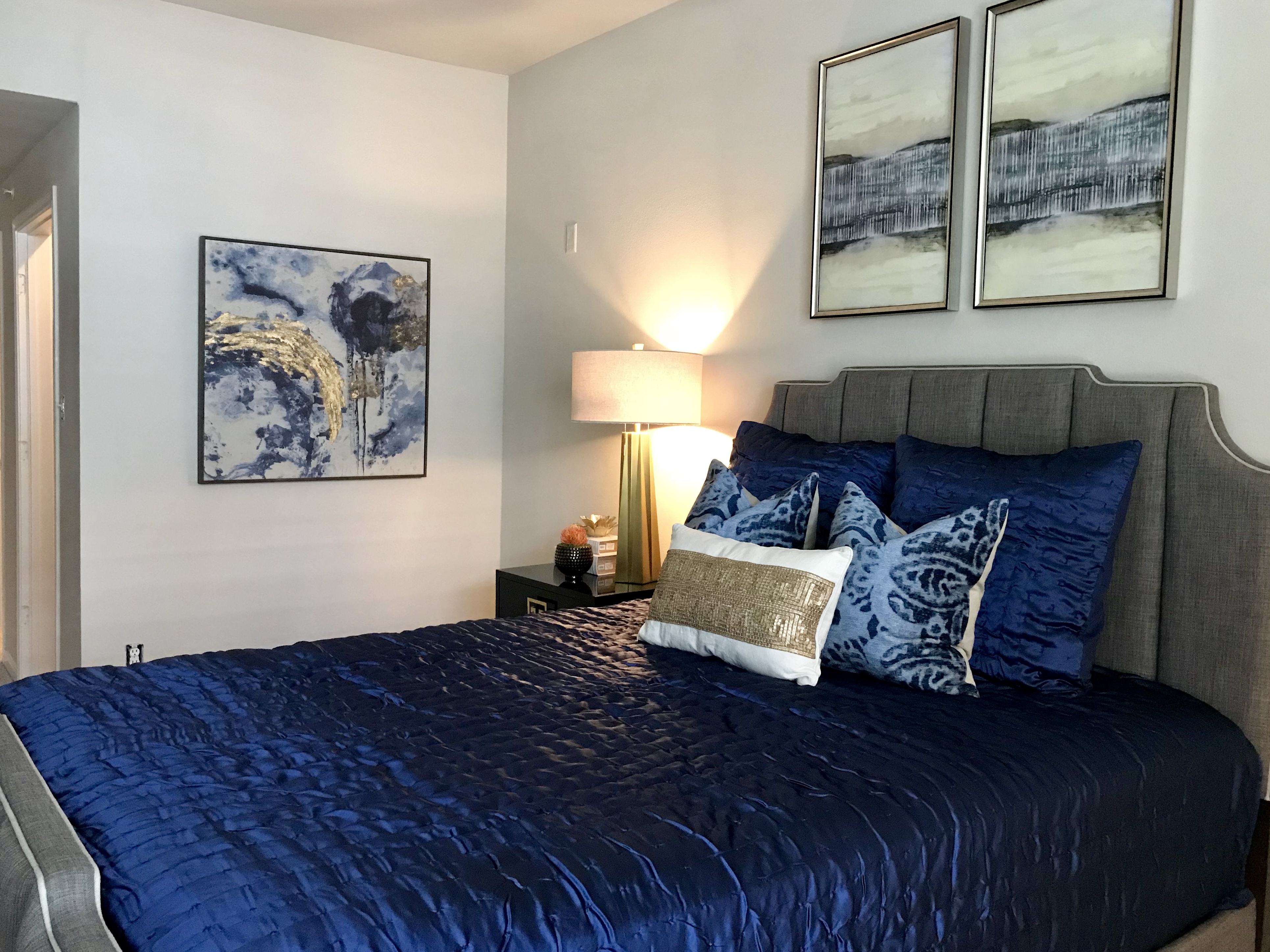 Bedroom with bed and decorative pillows.