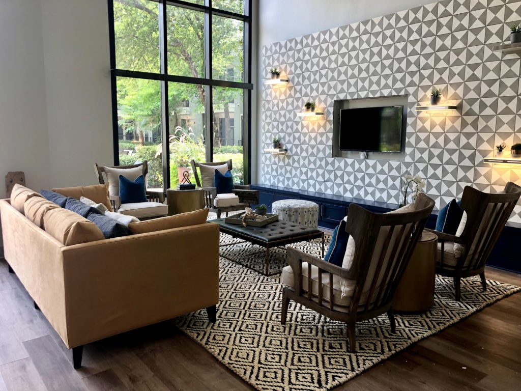 Living room in earth tones with sofa, chairs and table