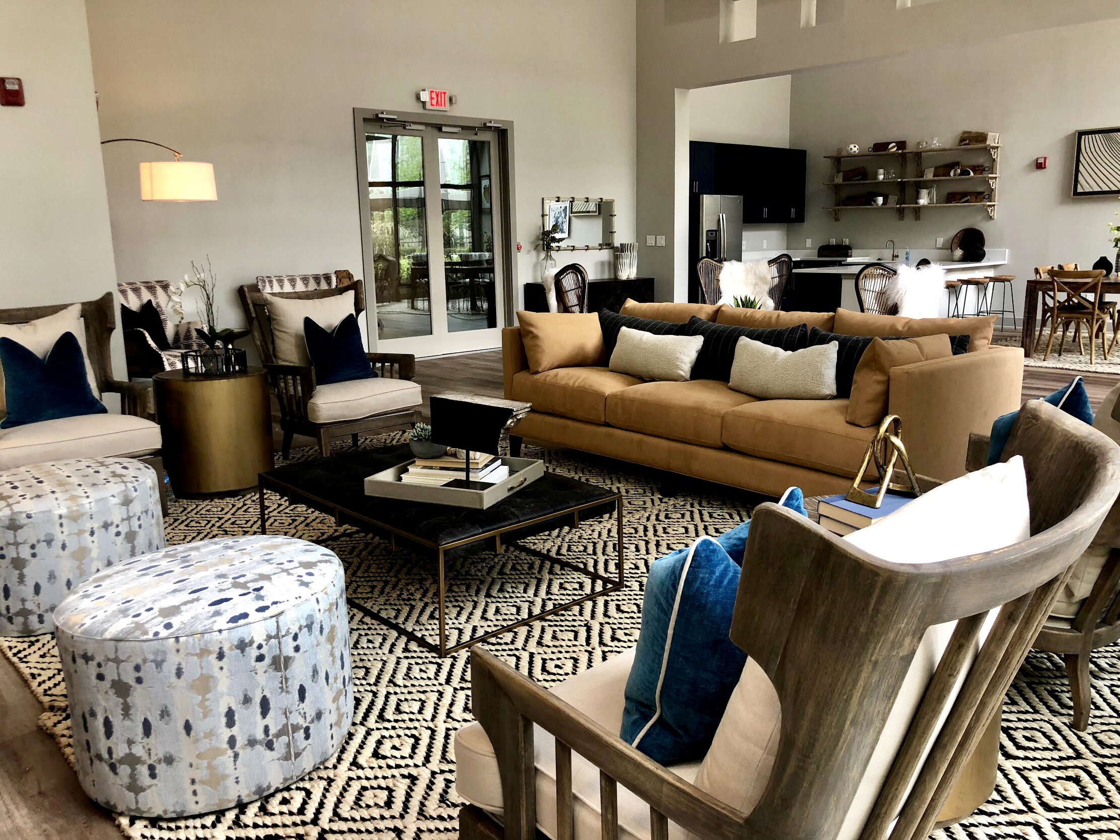 Living room in earth tones with sofa, chairs, table and accent pillows