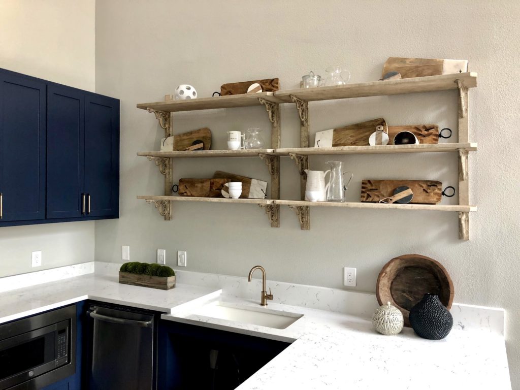 White kitchen sink and rustic wooden shelves