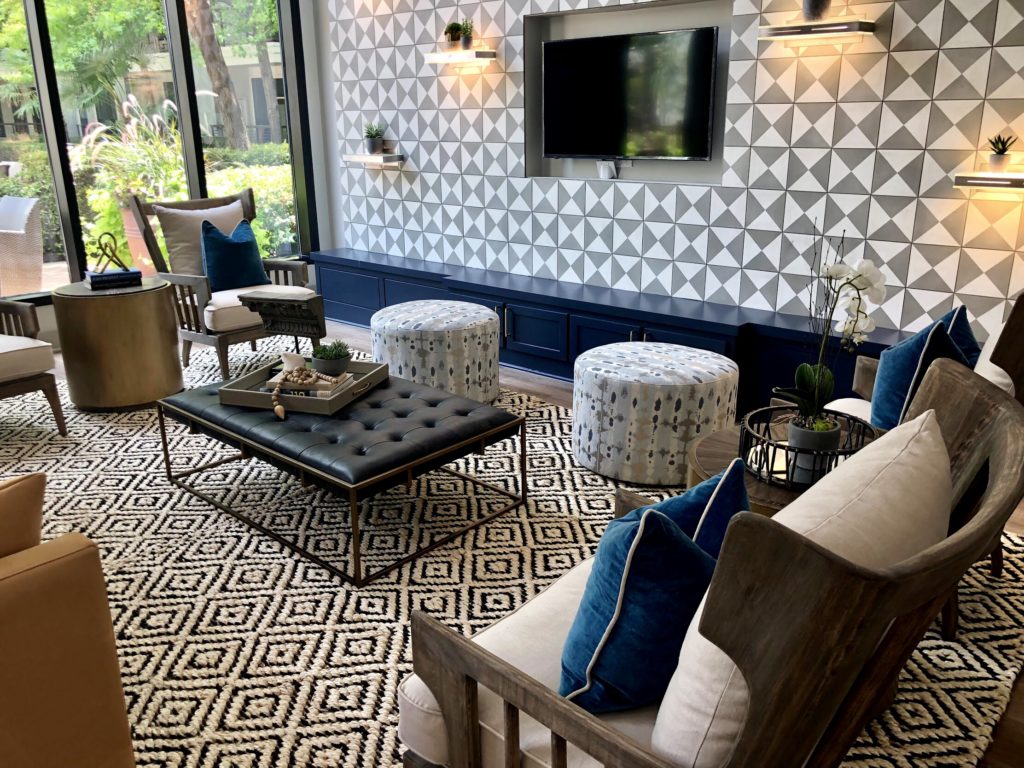 Living room in earth tones with sofa, chairs, table and accent pillows