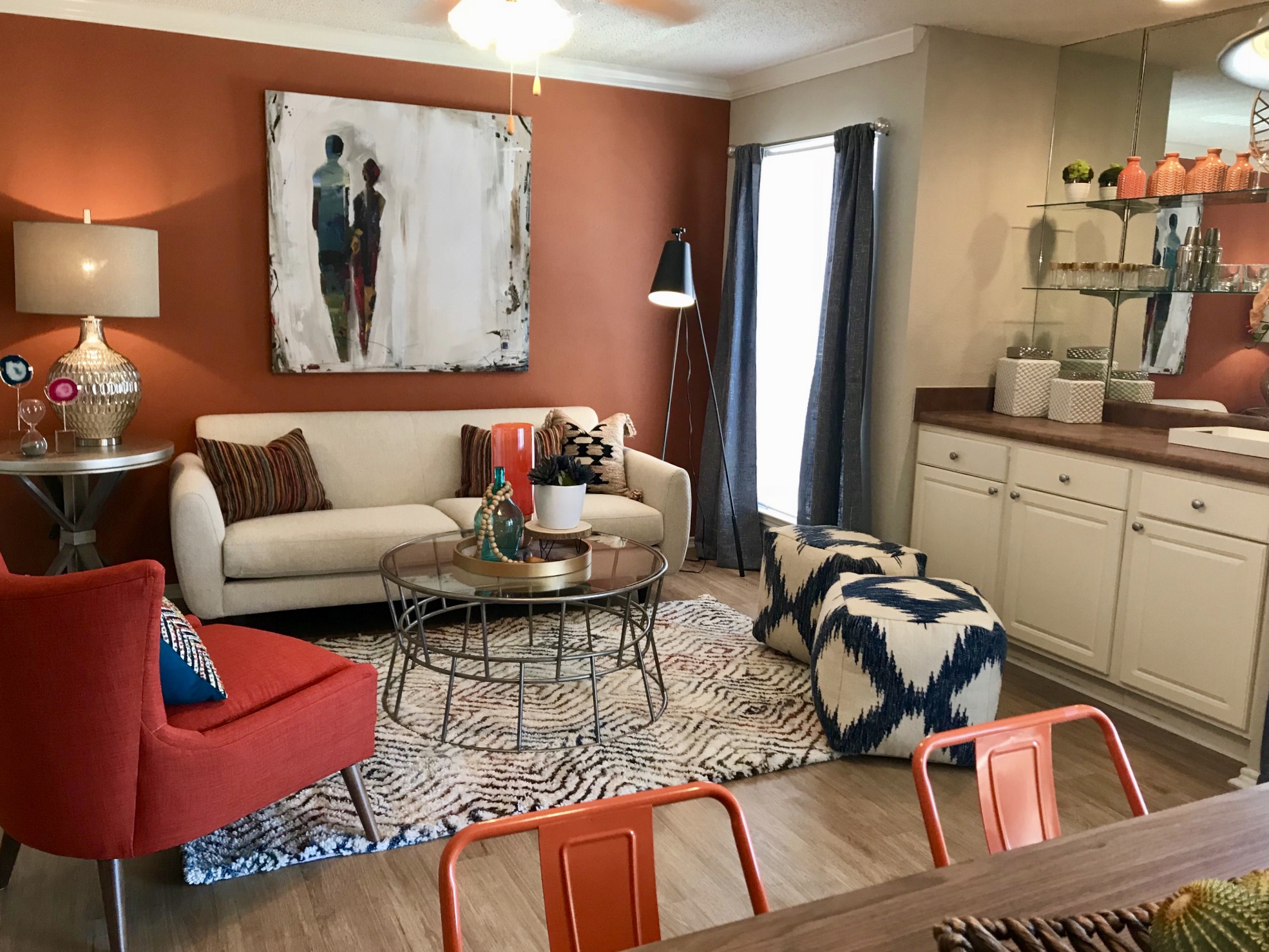 Living room with sofa, table and chairs in primarily scarlet accent colors 