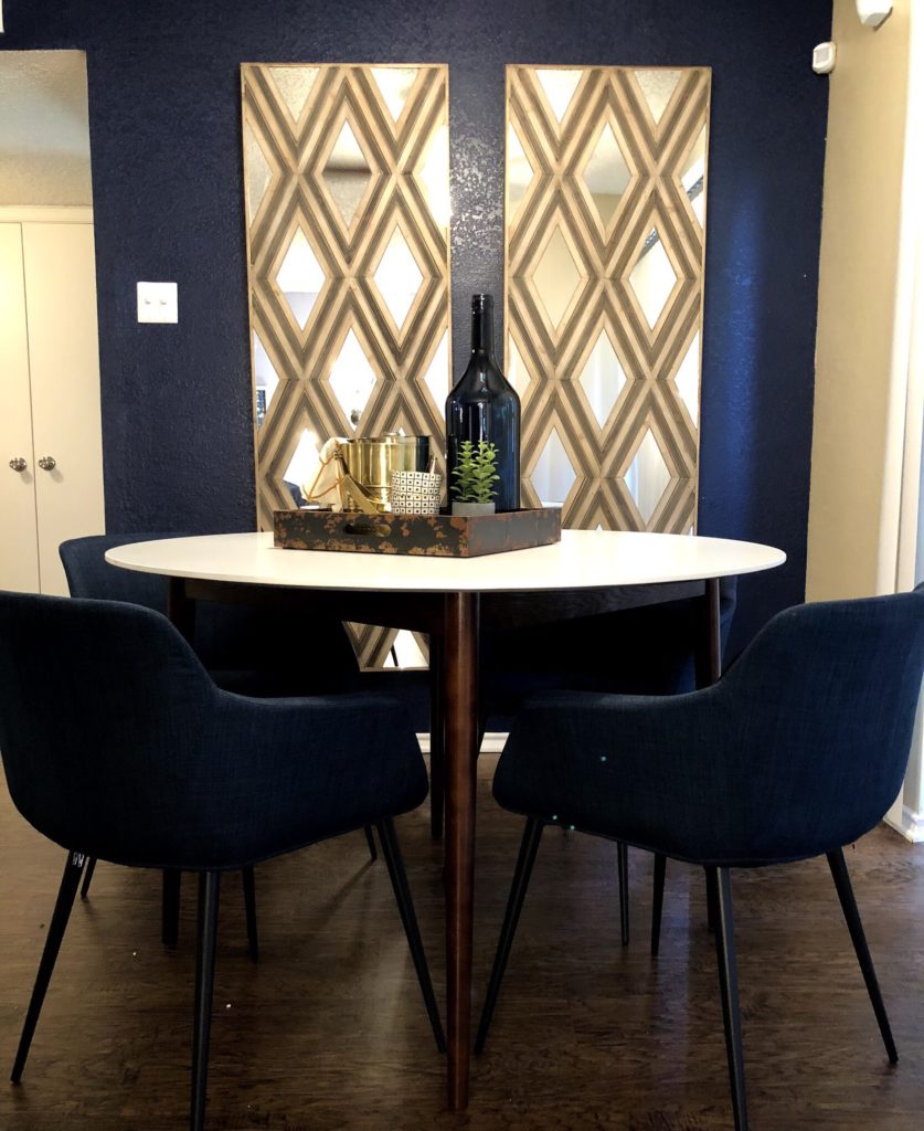 Dining area with round table and blue chairs