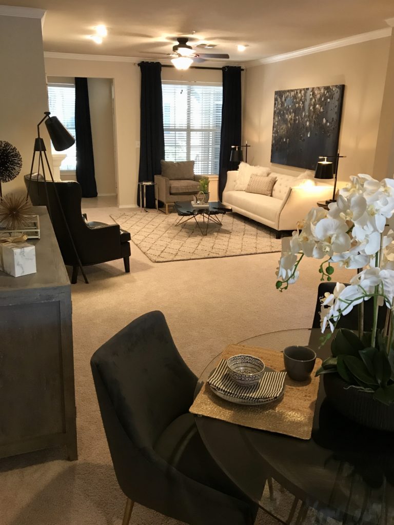 Warm lighted living room in black and neutral tones