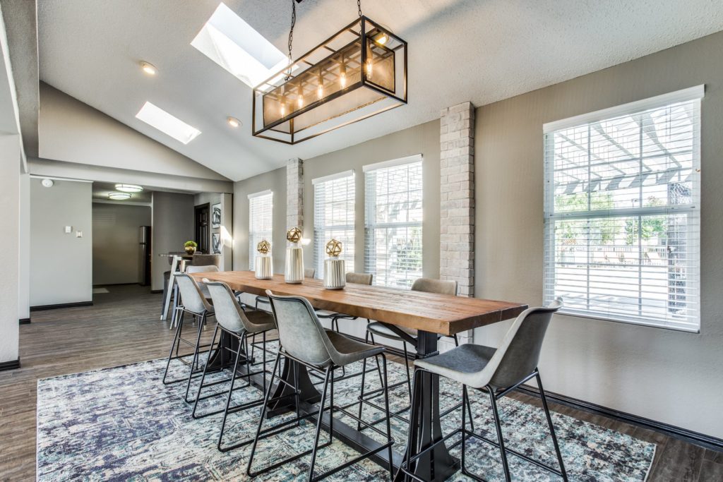 Club room makeover dining area with long table and high chairs for seating