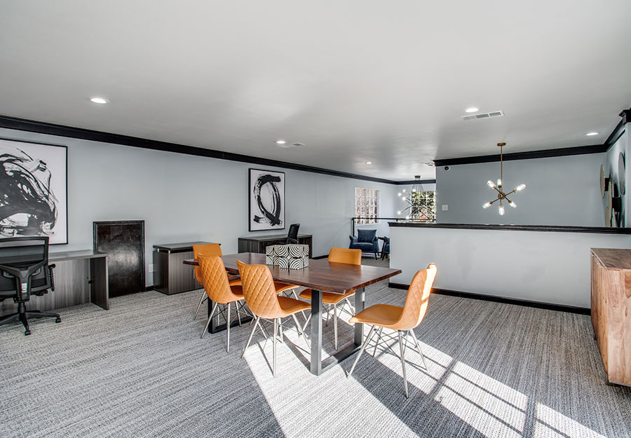 Multifamily renovations included this Business center with new paint and pops of orange