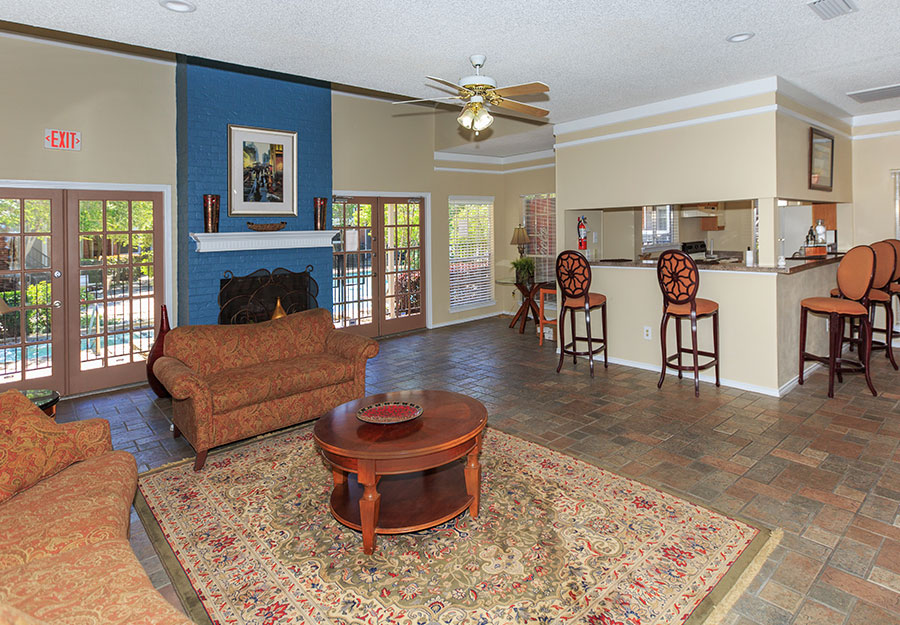 Photo of clubroom before the multifamily design renovations.  Low ceilings and closed off kitchen