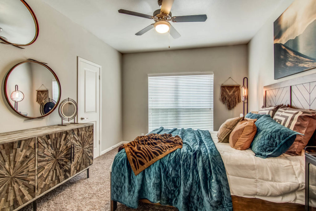 Earthy color palette in this custom apartment model bedroom