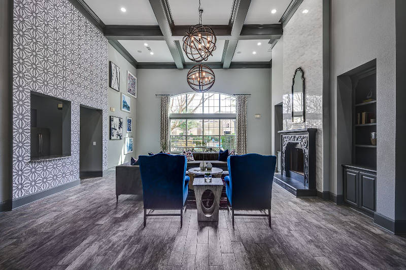 Living room with blue chairs and patterned wall