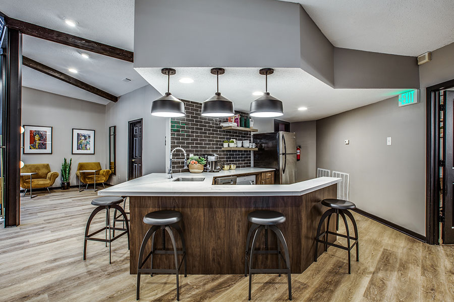 Kitchen area with bar seating and modern lighting