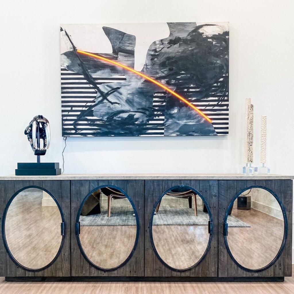 Mirrors and lighted artwork help this credenza to standout