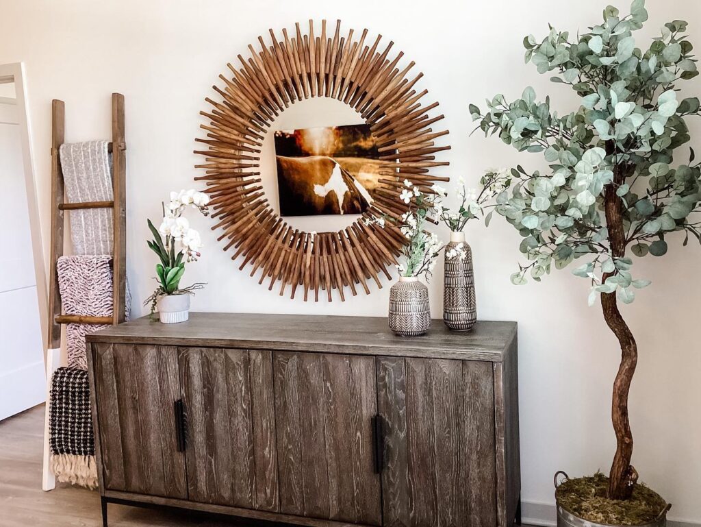 Simple credenza with a bold gold mirror above.