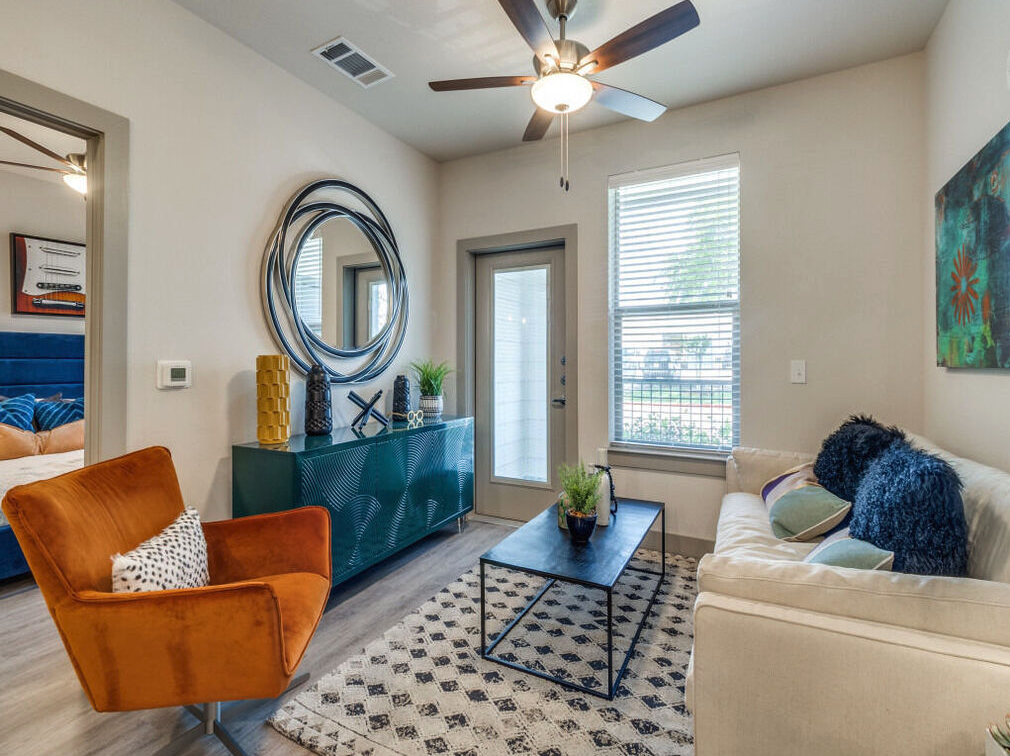 living room with orange velvet accent chair