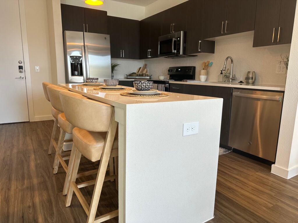 Kitchen with artwork and leather barstools