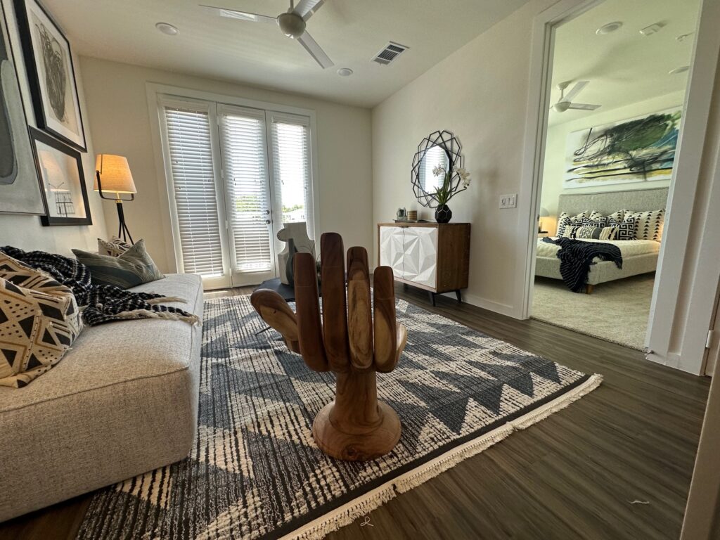 Living area with view into main bedroom for the custom apartment model