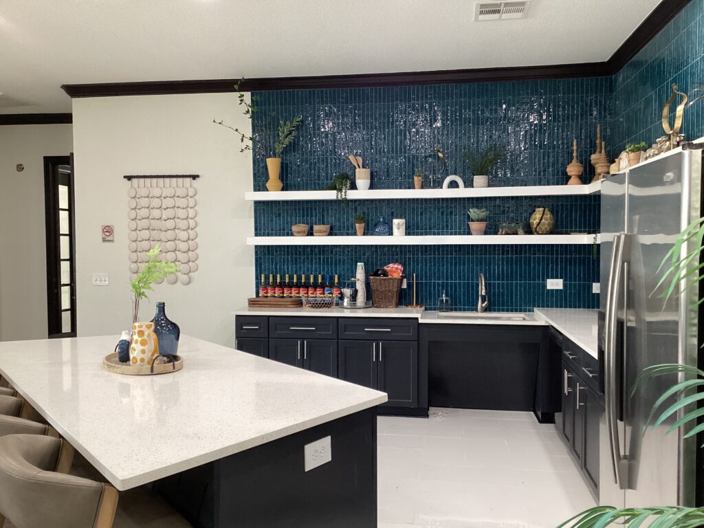 After photo of the newly renovated kitchen with open shelving and gorgeous sapphire blue tile backsplash