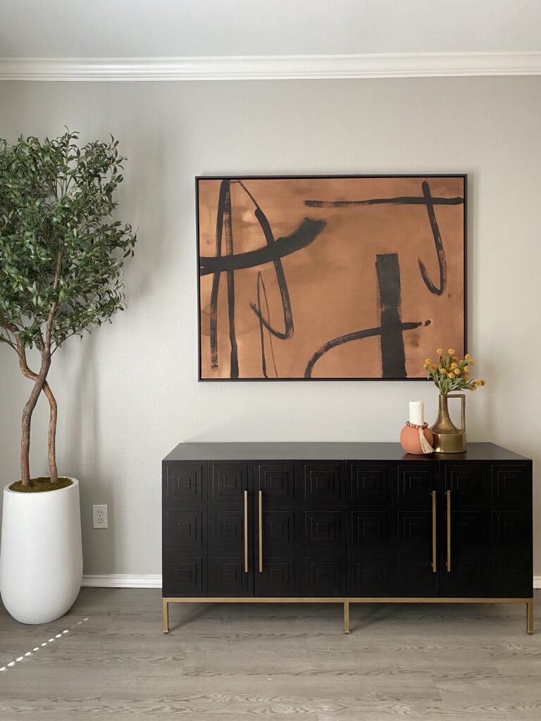 Living area with console table and decorative items, portrait orientation.