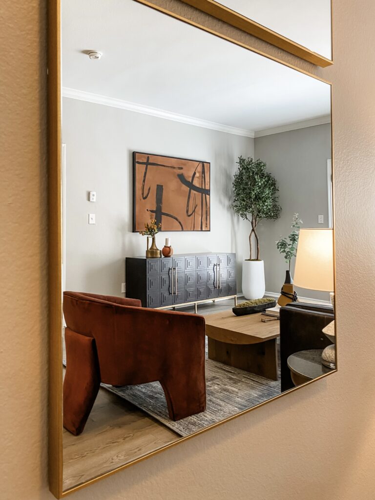 Living area reflected in a mirror, showing modern decor and furniture