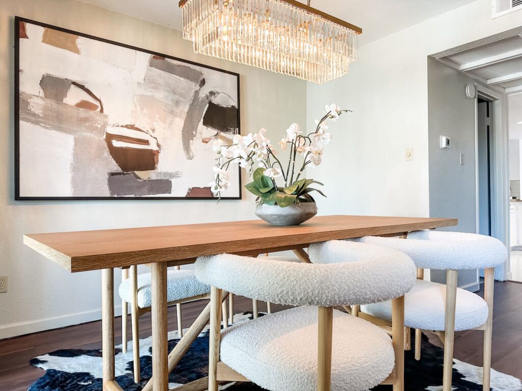 Dining Room staged with abstract artwork and boucle chairs