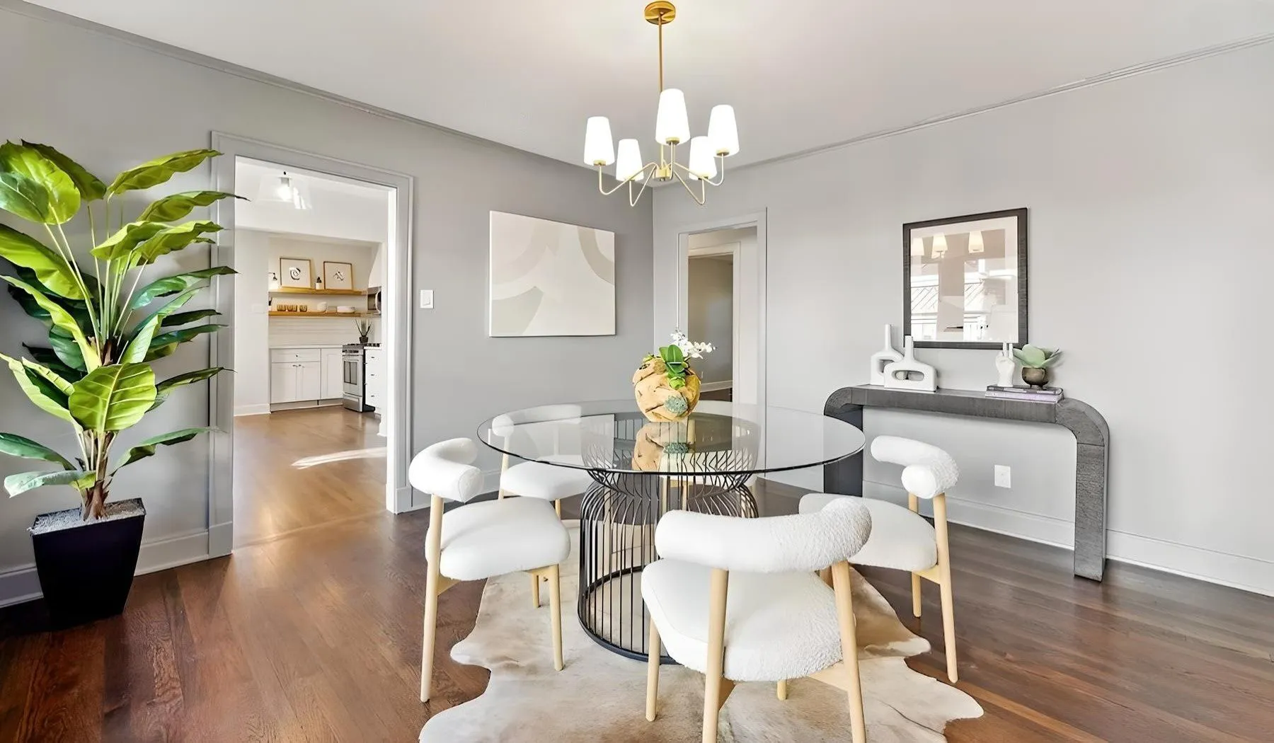 Home staging in Dallas of modern dining room with glass round table and white chairs