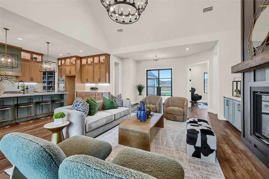 Home Staging living room with grey sofa, green pillows and two green chairs.