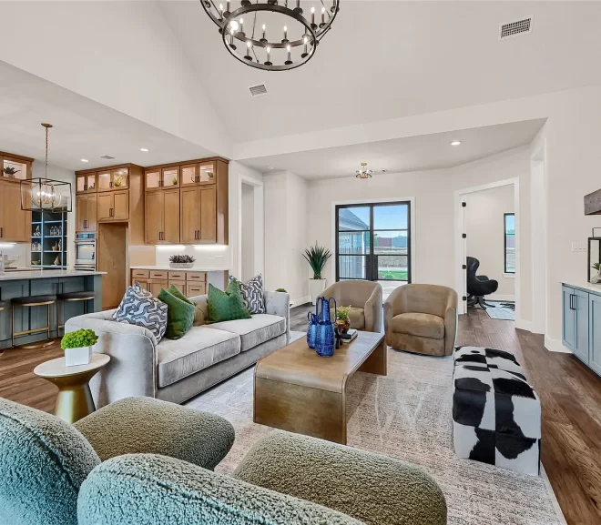 Home Staging living room with grey sofa, green pillows and two green chairs.