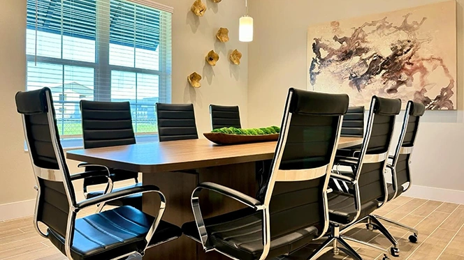 Office conference room with large table and six executive conference chairs