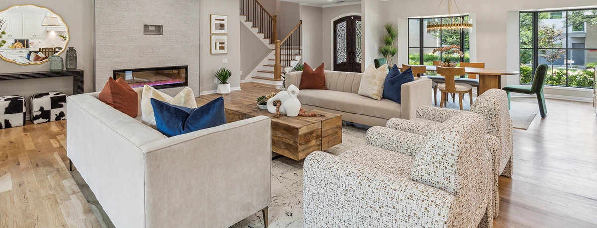 Living room with tan leather sofas and colorful pillows