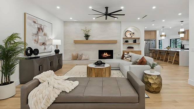 Modern living room with light grey sofa l-shaped sofa, grey bench and neutral colored accents