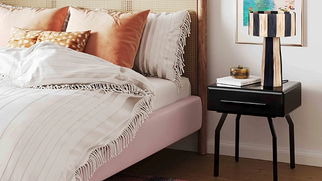 Modern black glass nightstand with one drawer and a white and black small lamp