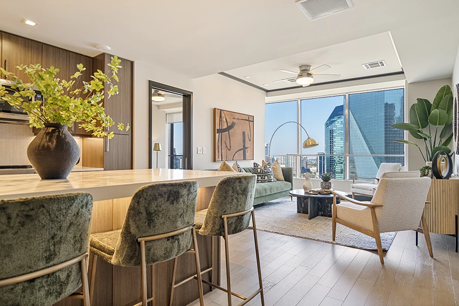 Modern living room and kitchen styled with green, gold and white furnishings and decor