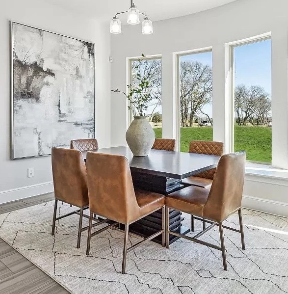 Dining room with square table and six light tan vegan chairs