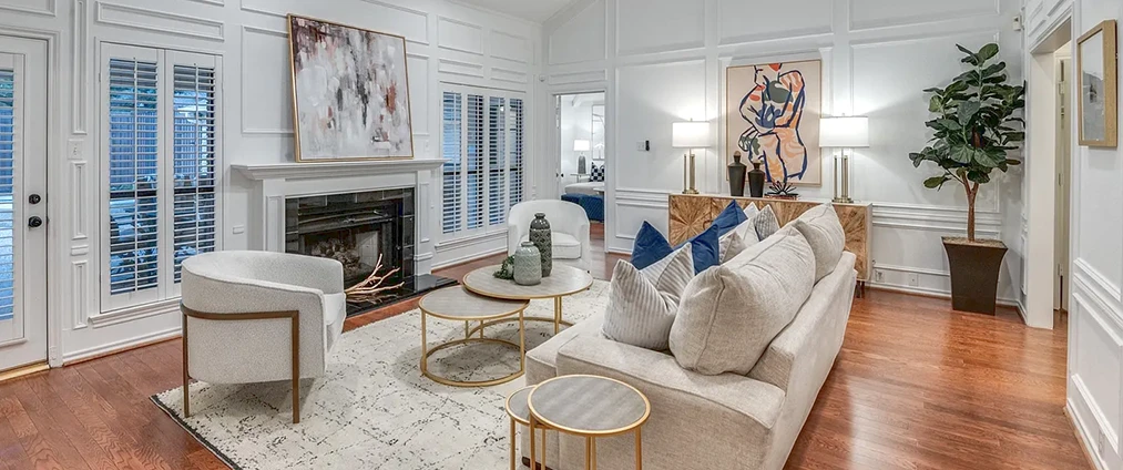 Living room with light colored furnishings and bright artwork