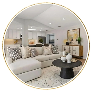 Living room with light grey sofa, round black coffee table and white console table