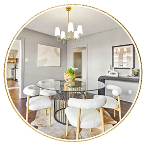 Dining room with round glass table, four white boucle chairs and rawhide rug