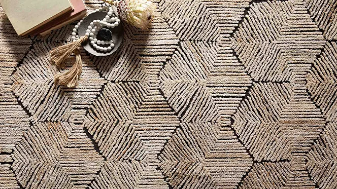 Closeup of a beige geometric patterned rug